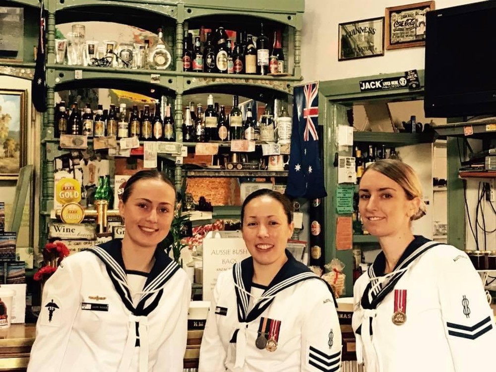 Group of three women in Australian Navy uniform smiling 